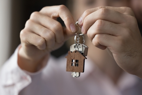 Unknown couple hands holding bunch of keys