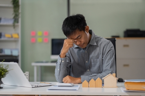 male cover her face after stressed with credit card debt, house debt bankrupt stress